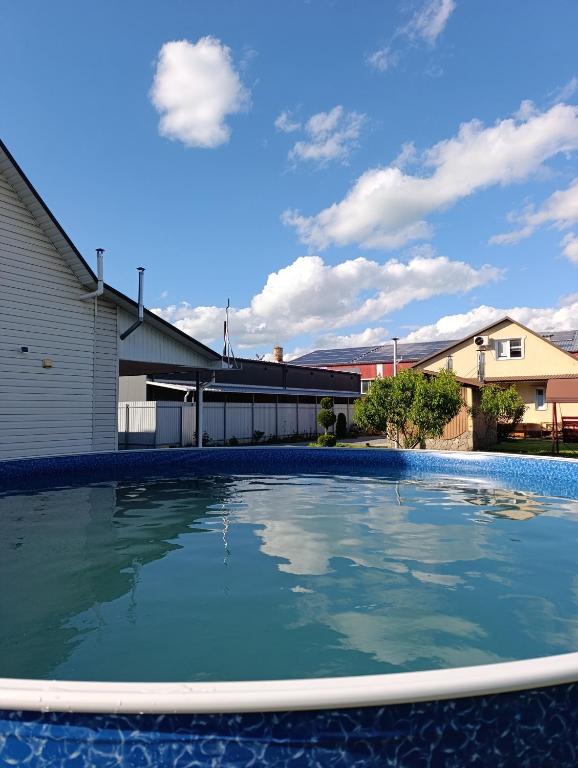 a large pool of water in front of a building at Фазенда in Bohuslav