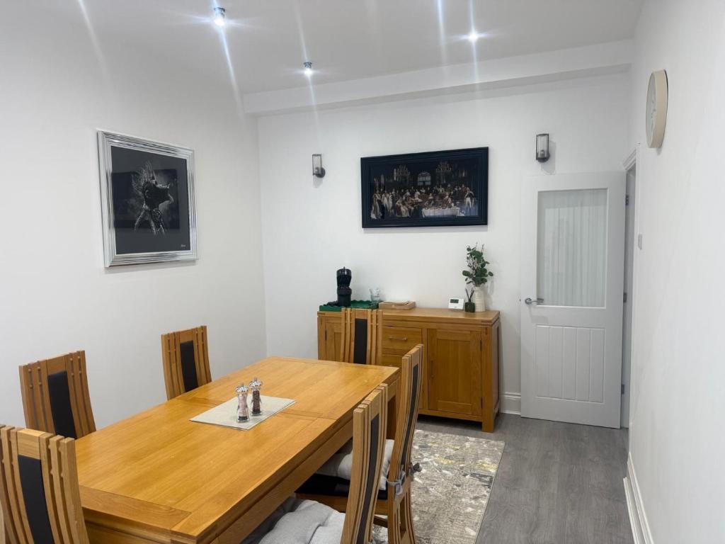a dining room with a wooden table and chairs at Nest in Northumberland 2 in Blythe