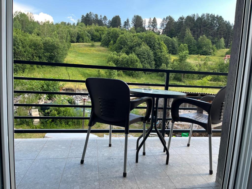 a table and chairs on a balcony with a view at Irvas Kolasin-400 metara od centra in Kolašin