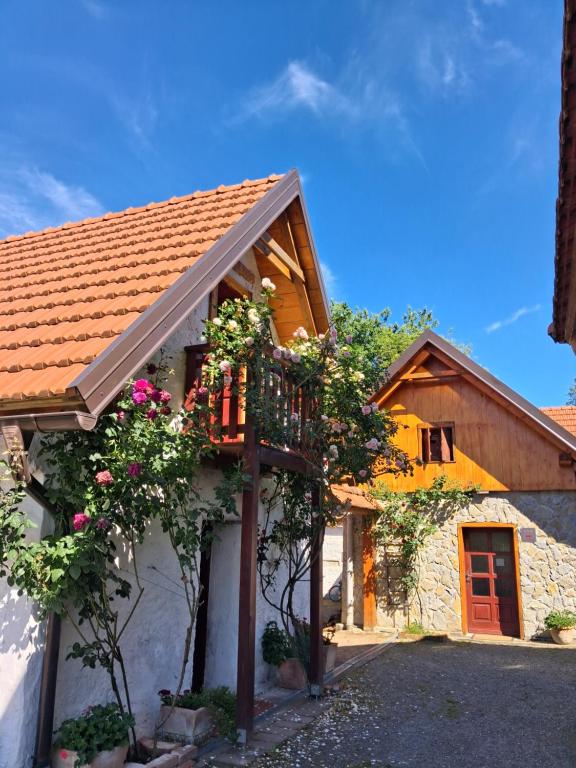 a house with a balcony and flowers on it at Soba Gallo in Latin