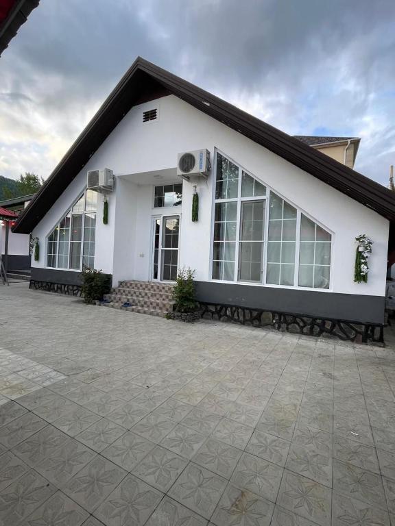 a white building with a black roof at Gabala Home in Gabala
