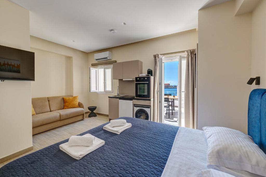 a bedroom with a large bed and a living room at Syranna in Ermoupoli