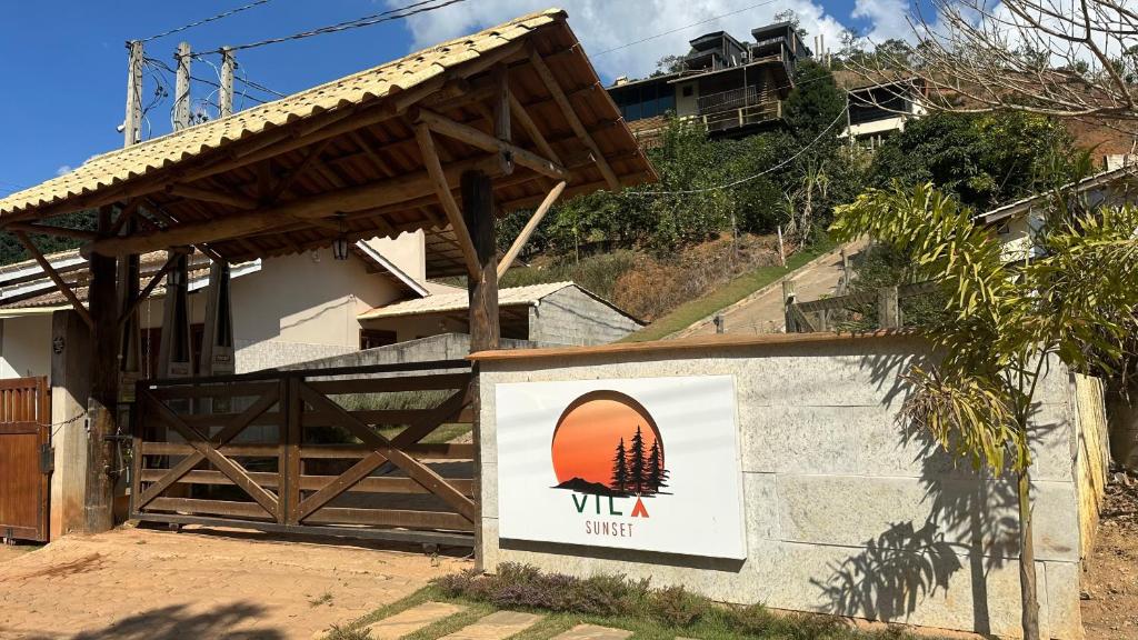 a building with a sign that reads vla village at Forest in Domingos Martins