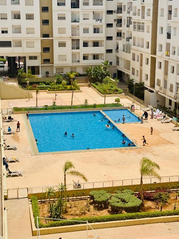an overhead view of a large swimming pool in a city at Islane Holiday Studio with pool&balcony in Agadir