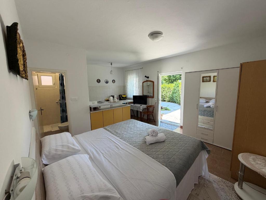a bedroom with a bed with a towel on it at Studio Apartman ISRA 1 in Palit