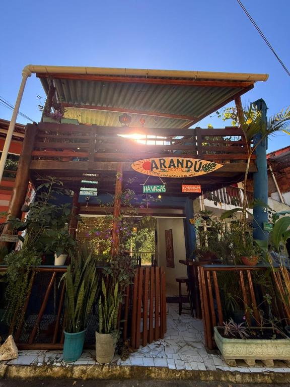 a restaurant with plants in front of a building at Arandú Hostel in Itacaré