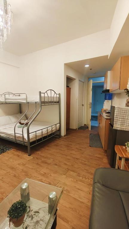 a living room with two bunk beds and a table at Mactan Cozy Hub Amani Grand in Lapu Lapu City