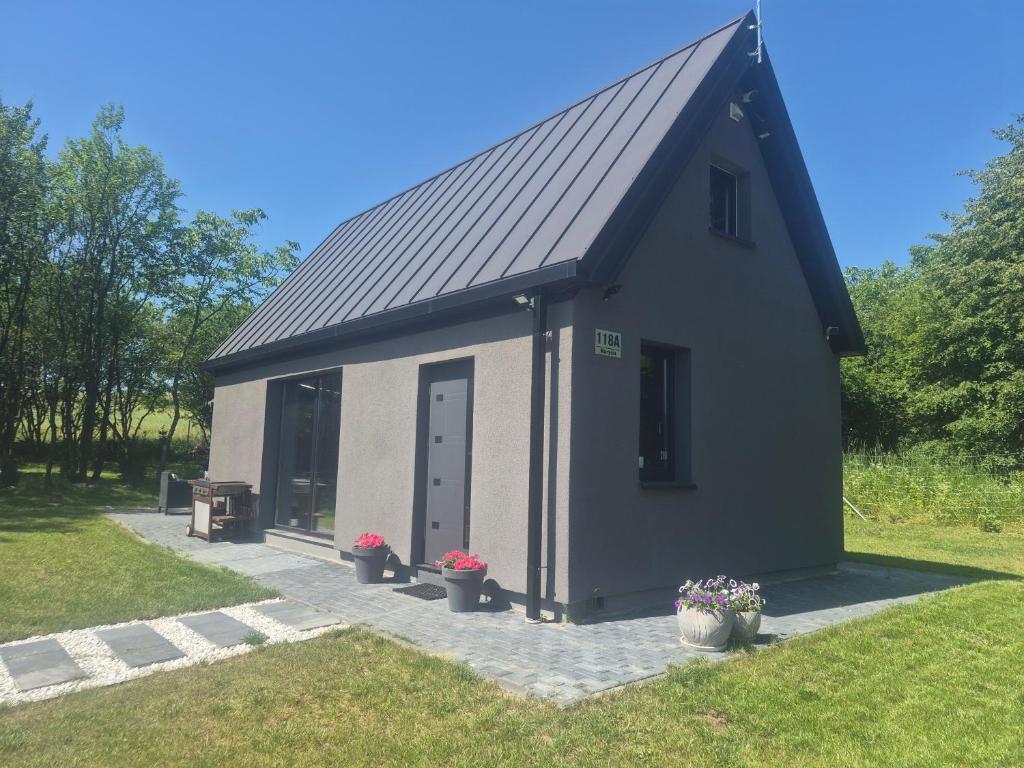 a small black and white building with a door at Sauna-ForRest in Marynin