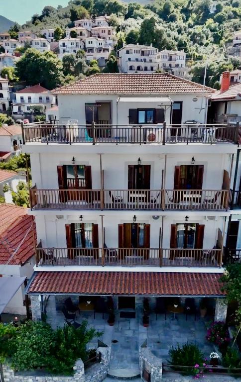 a large white building with balconies on top of it at Aetherion in Agios Ioannis Pelio