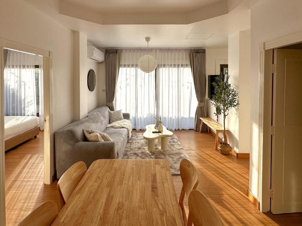 a living room with a table and a couch at Link Mansion in Chiang Mai