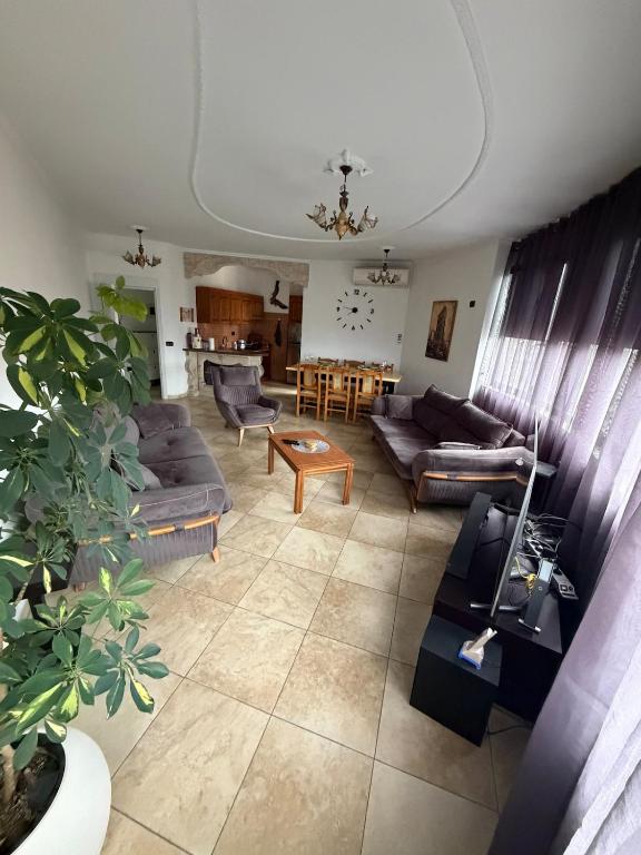 a living room with couches and a table at Tirana Skyline Apartment in Tirana