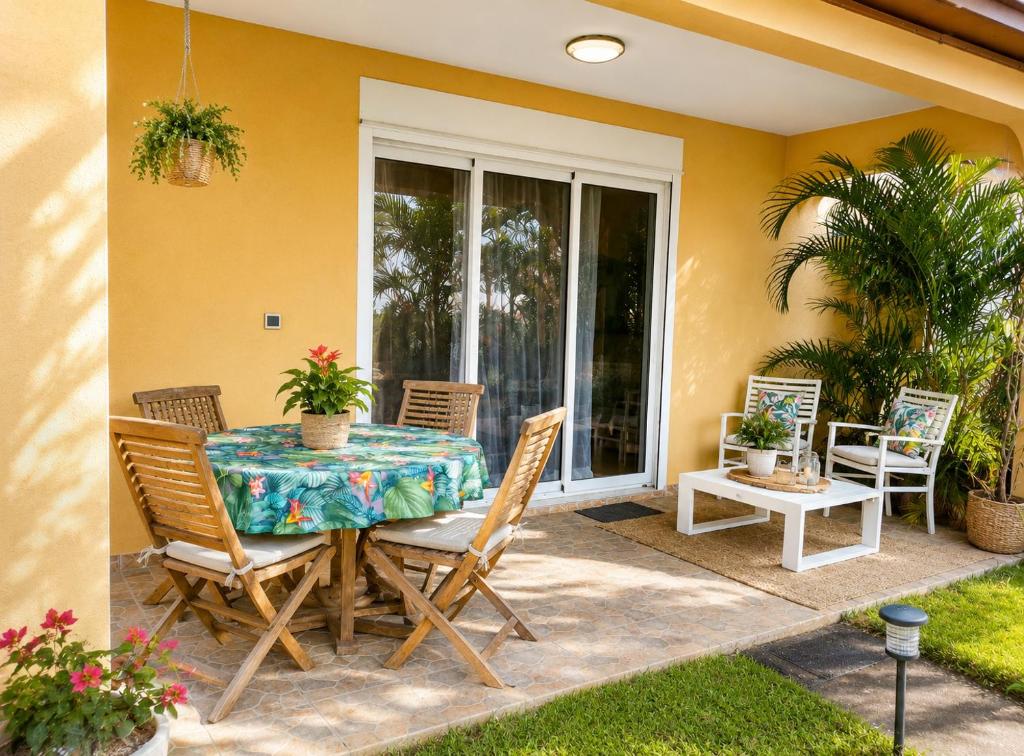 a patio with a table and chairs on a patio at Ti kaz Annah in Le Tampon