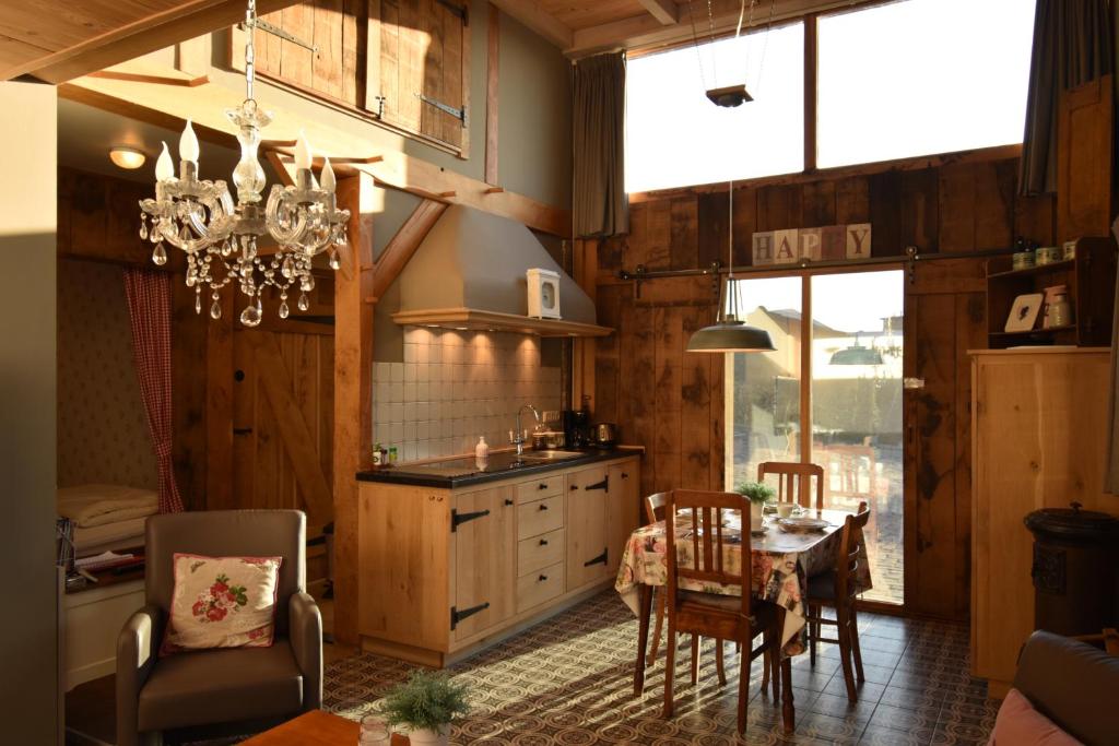 a kitchen with a table and chairs and a dining room at Hof Kricheleberg in Bocholtz