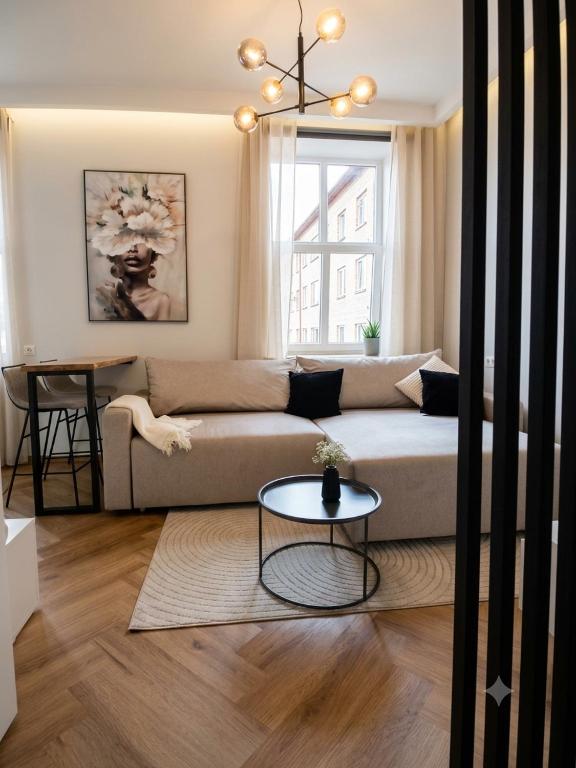 a living room with a couch and a table at Keskväljaku Studio apartment in Võru