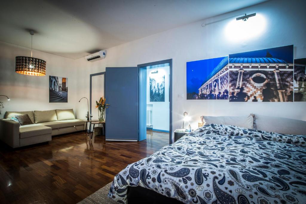 ein Schlafzimmer mit einem großen Bett und einem Sofa in der Unterkunft Mi&Ti Bed&Breakfast in Vicenza