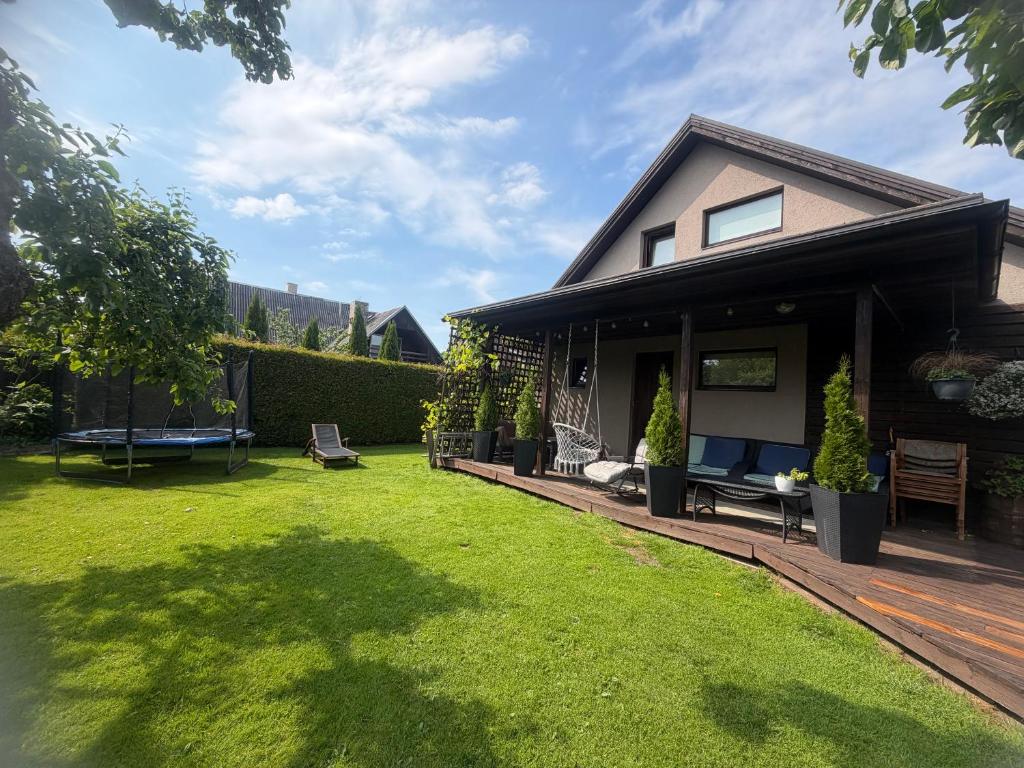 a house with a yard with green grass at Mooni Cottage in Pärnu