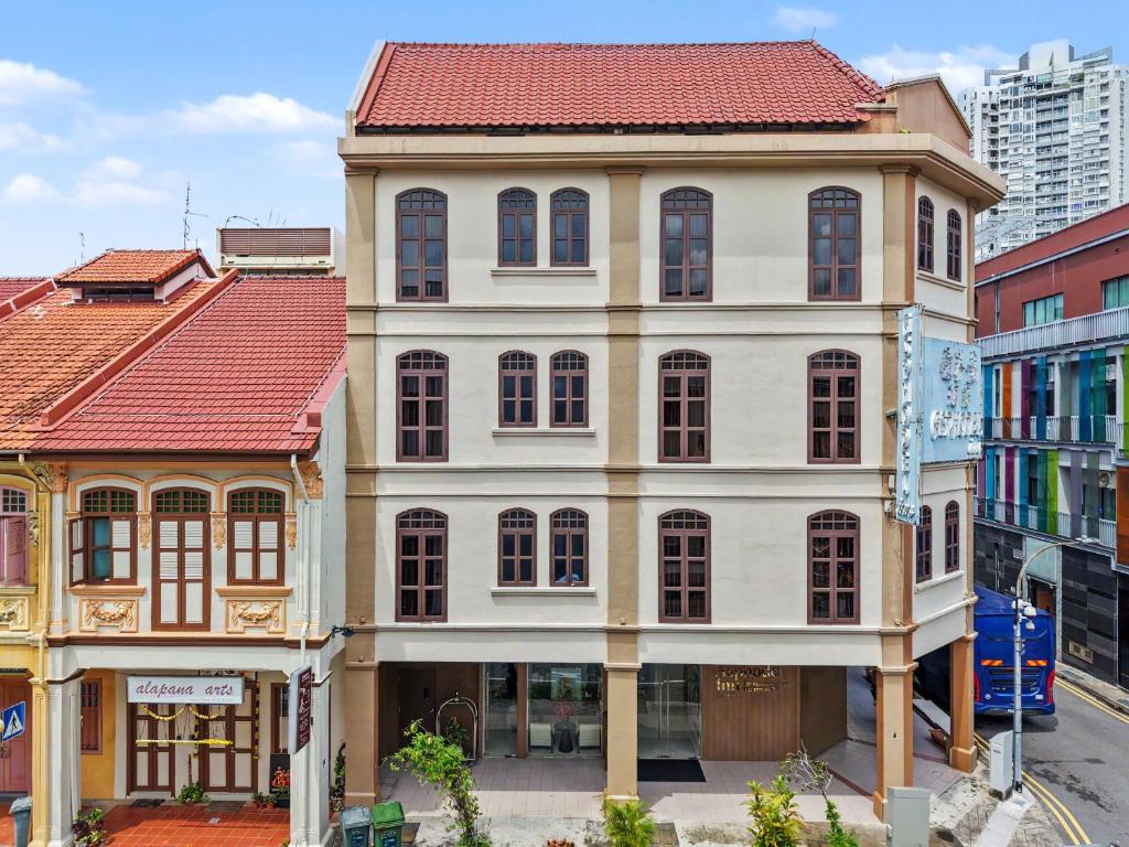 a large white building with a red roof at Asphodel Inn - Newly Renovated in Singapore