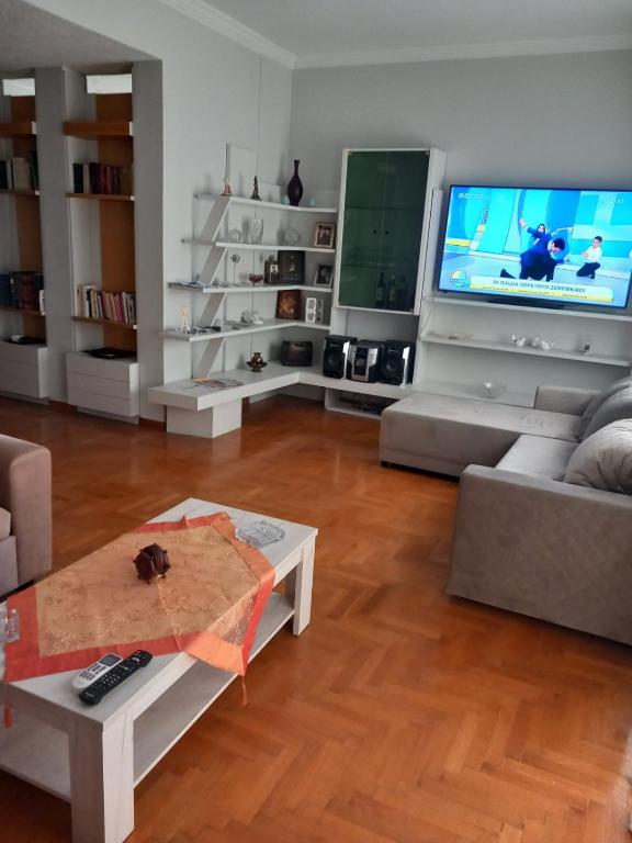 a living room with a couch and a tv at Lamia House in Lamía