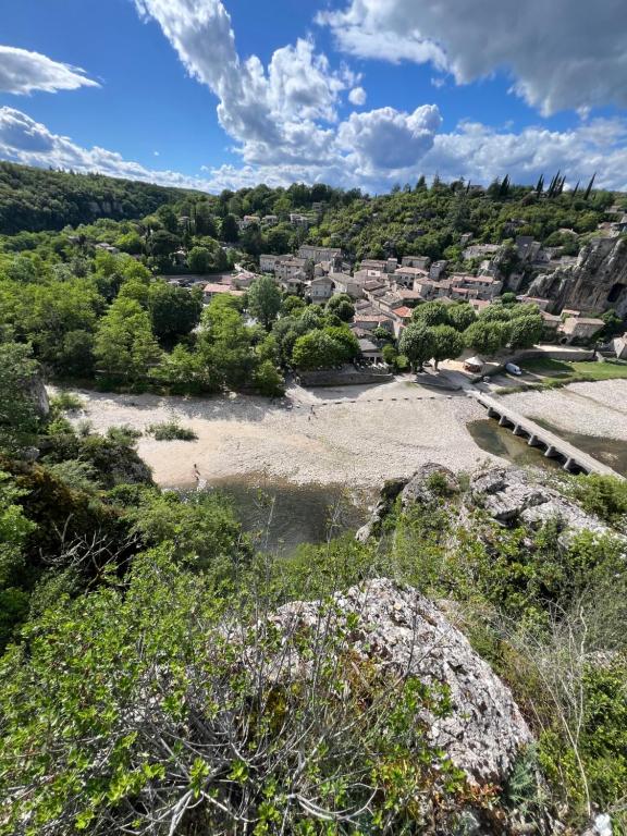a view of a river with a town in the background at Chamalobri in Labeaume
