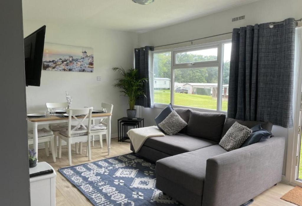 a living room with a couch and a table at Cosy Cabin in Bucks Mills