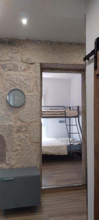 a room with a bunk bed and a mirror at O rincón do Mimo in Ribeira