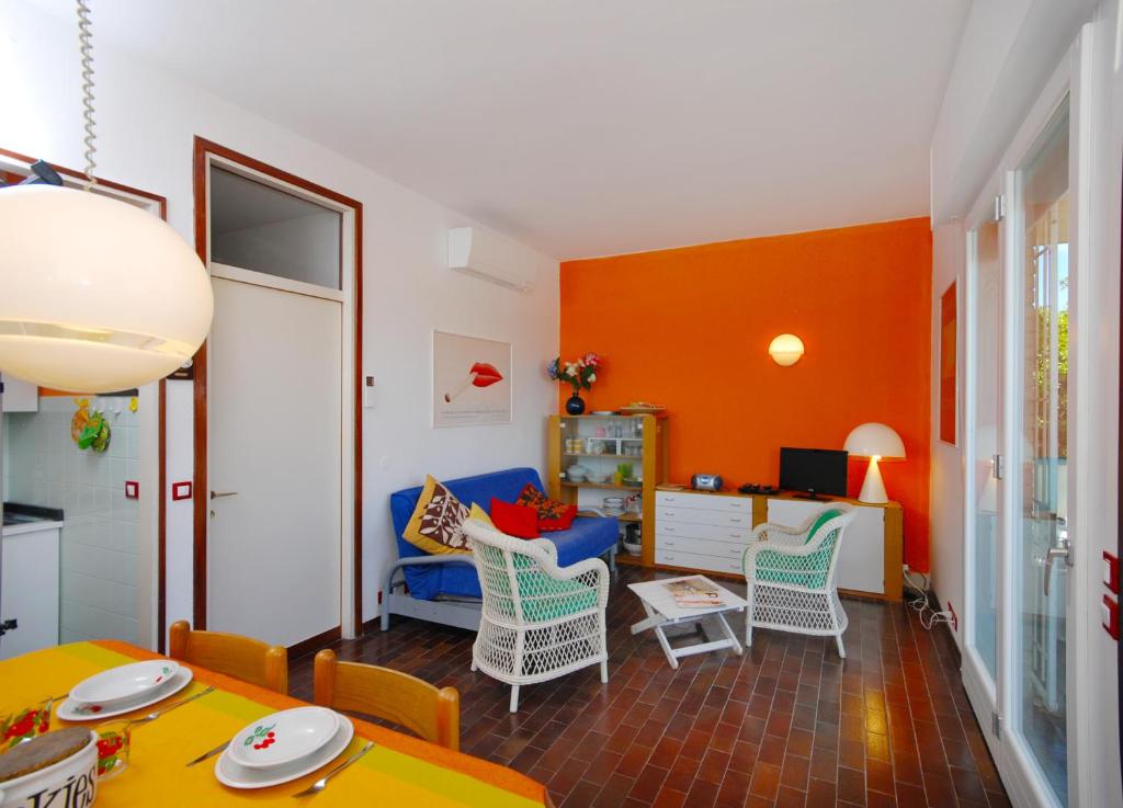 リド・ディ・イエゾロにあるNiceflatのオレンジ色の壁のリビングルーム(青いソファ付)