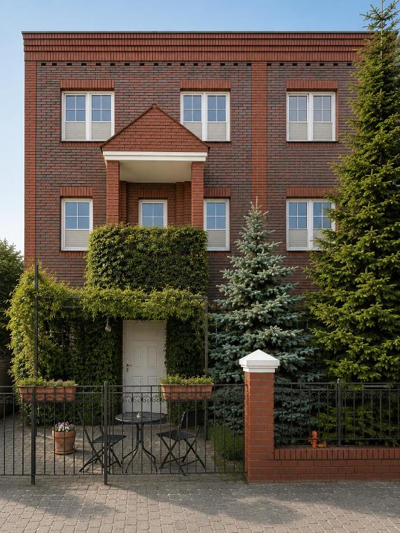a brick building with a table in front of it at Villa Jeziorki in Warsaw