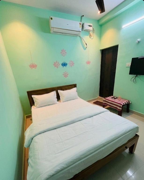 a bedroom with a bed and a air conditioner on the wall at Gravity Groups Core - Star residency in Pondicherry