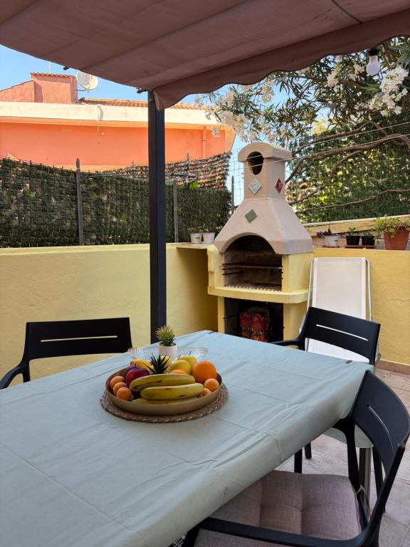 a table with a plate of fruit on top of it at Castelsardo Homes in Castelsardo