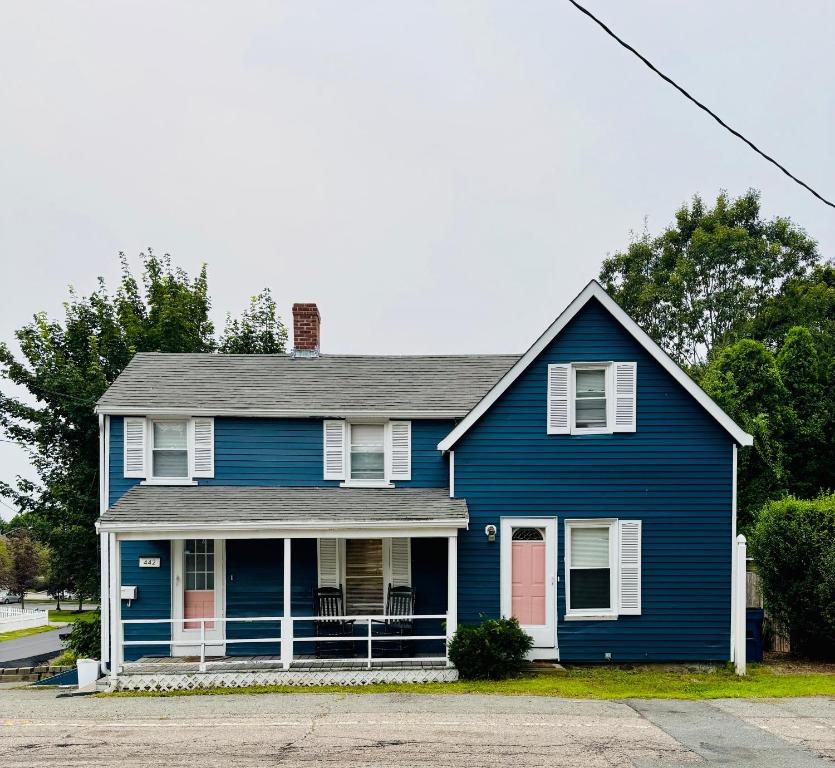 a blue house with a red door at Pet friendly cottage near Boston in Canton