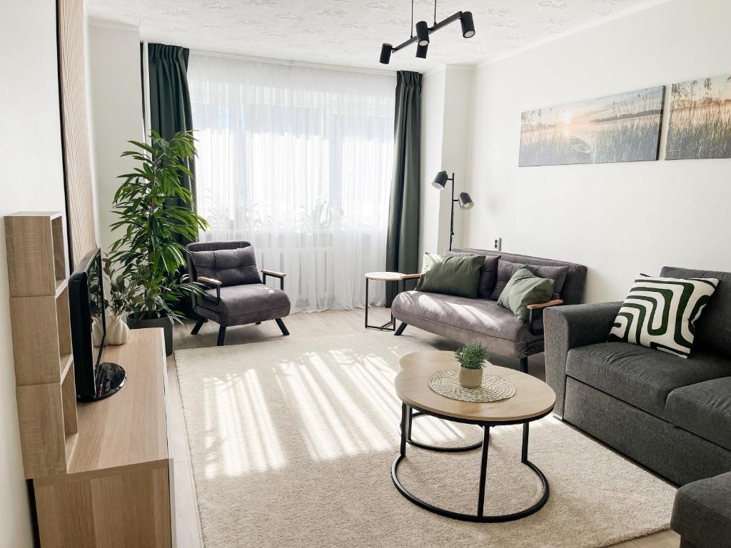 a living room with a couch and a table at 2-Room Apartment in Lahemaa Near the Sea in Loksa