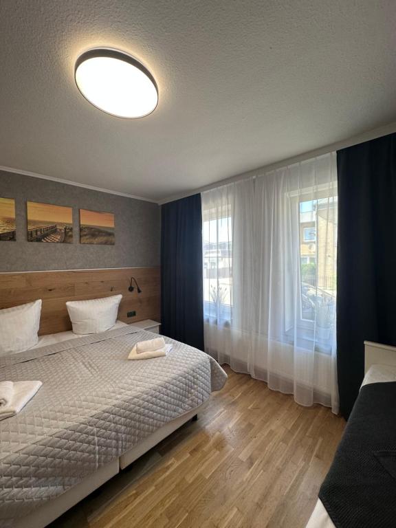 a bedroom with a bed and a large window at Ferienwohnung Waldblick in Harrislee