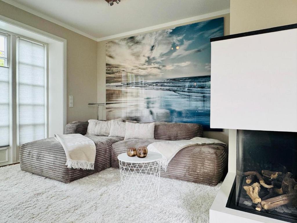 a living room with a couch and a painting at Haus Magnus SeaSide in Sylt