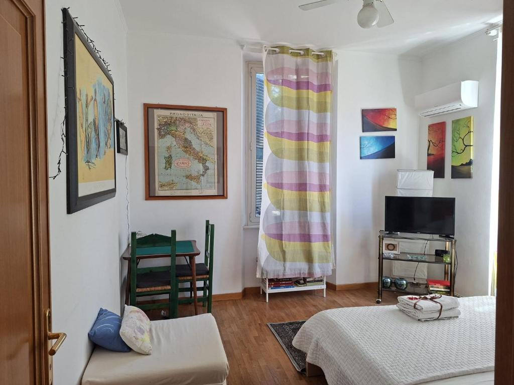 a living room with two beds and a television at La Casetta di Benedetta in Rome