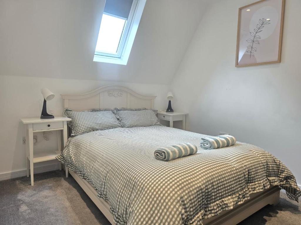a bedroom with a bed with two tables and a window at Grace's Place in Milton in Milton
