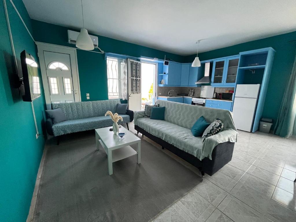 a living room with a couch and a table at Bella's House in Theologos