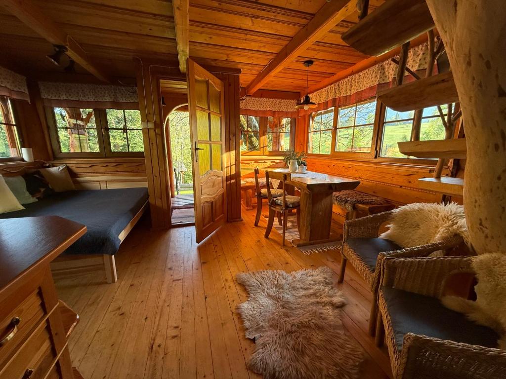a living room with a couch and a table in a cabin at Chalúpka u líšky Elišky in Ždiar