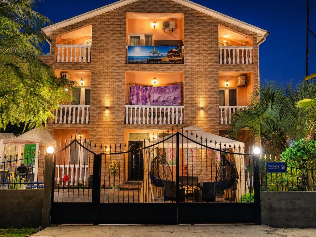 a brick building with a gate in front of it at Hotel Jacob in Ureki