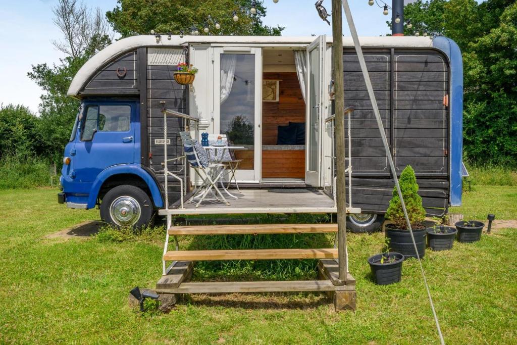 a blue van parked in a yard with a house at 1 Bed in Elsing oc-d44229 in Elsing