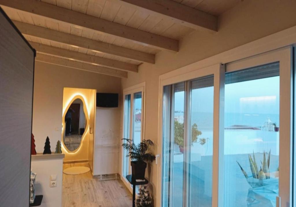 a living room with a view of the ocean at VueSurMer Amarynthos in Amarynthos