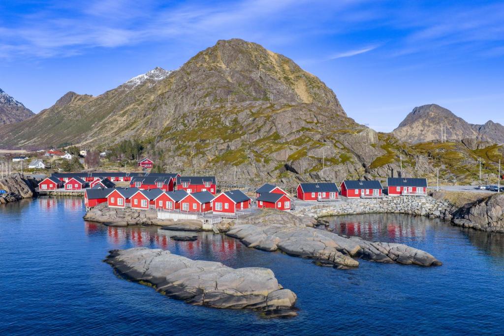 a group of red houses on a island in the water at Statles Rorbu- og Konferansesenter AS in Leknes