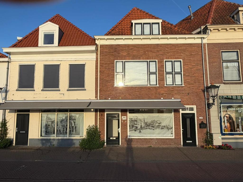 a large brick building with a store front at Herberg de Smederij in Kampen