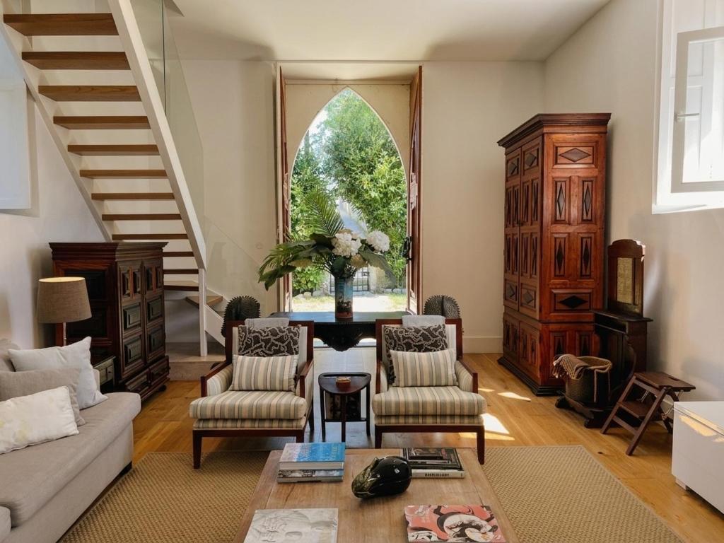 a living room with a couch and chairs and a table at A Capela - A Essência de Sintra in Sintra