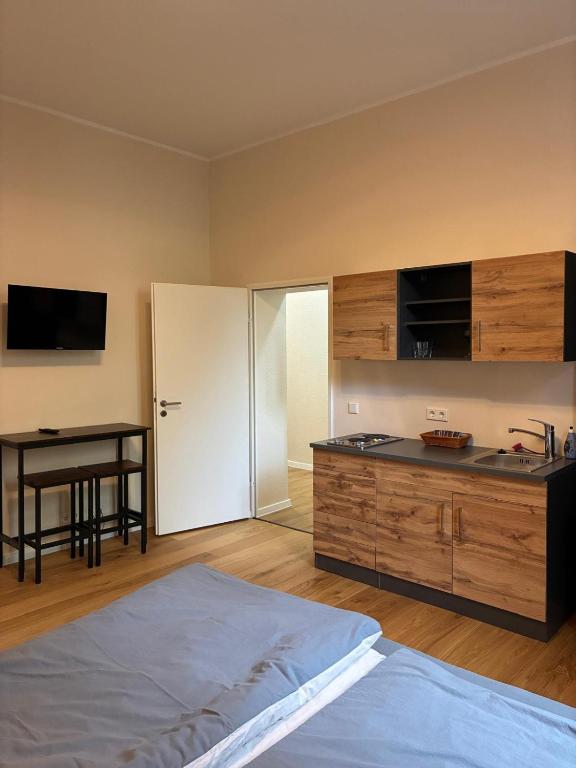 a bedroom with a bed and a desk and a table at Gästehaus Lelo 1 in Solingen