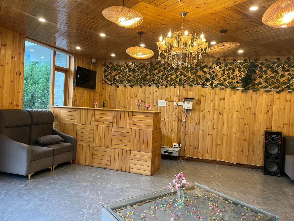 a living room with a couch and a chandelier at MK Resort in Palchān