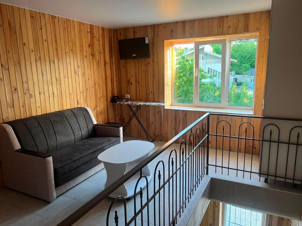 a living room with a couch and a table at Апартаменти Атаман in Zhovtnevoye