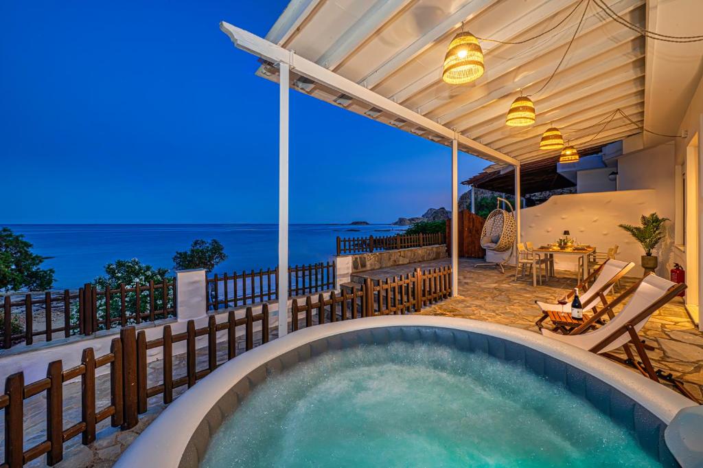 a pool on a house with a view of the ocean at Oniro Beach House in Archangelos