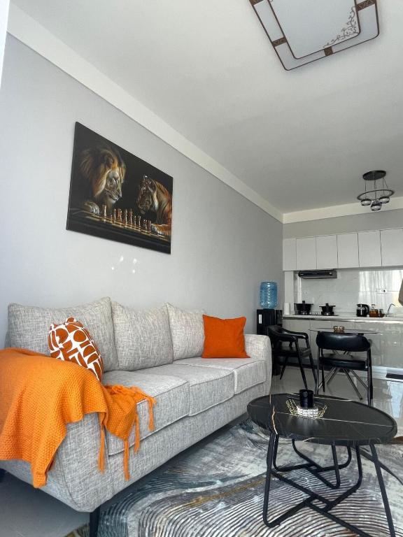 a living room with a couch and a table at Cozy Nest in Marimbeti