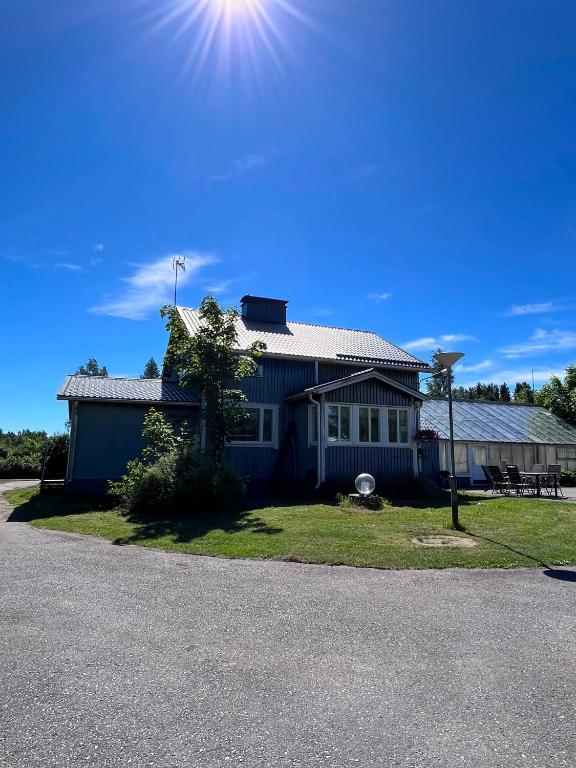 a blue house with the sun in the sky at Villa Puutarha, Merikarvia in Merikarvia