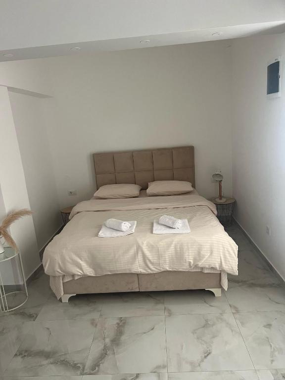 a bedroom with a bed with two towels on it at Studio Apartment Vukcevic 3 in Golubovci